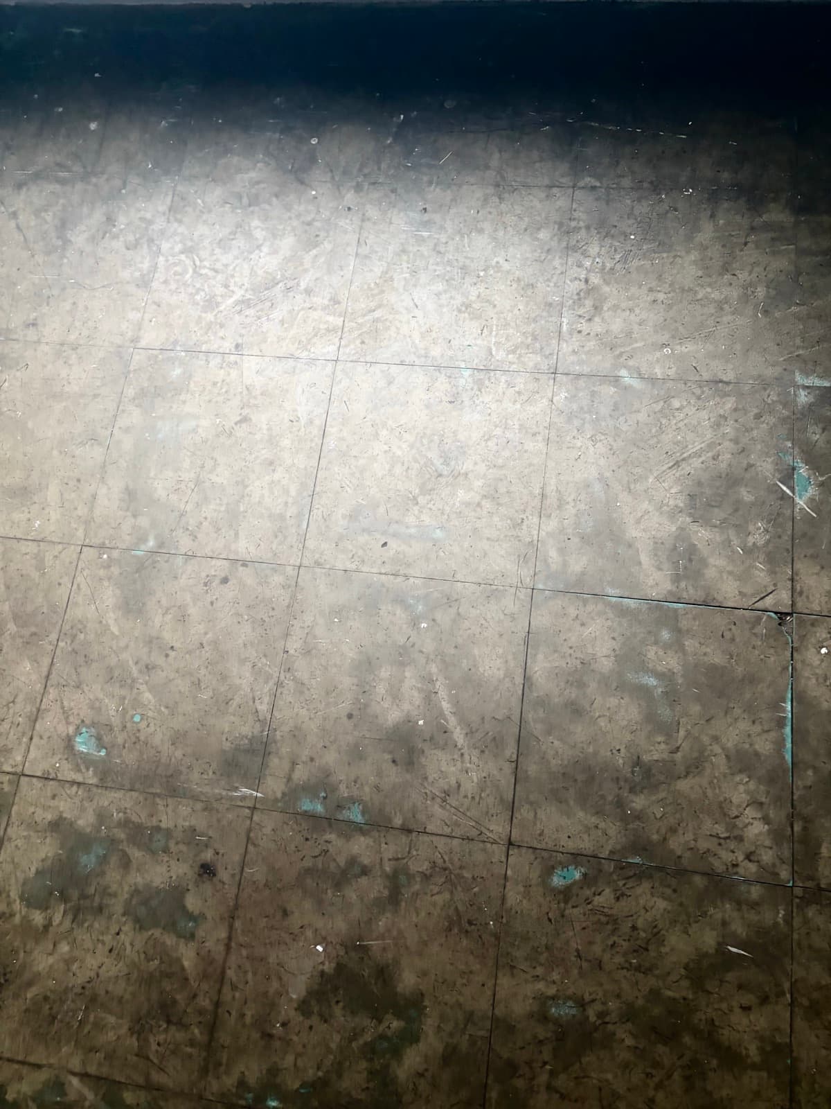 Worn tiled floor texture inside the venue
